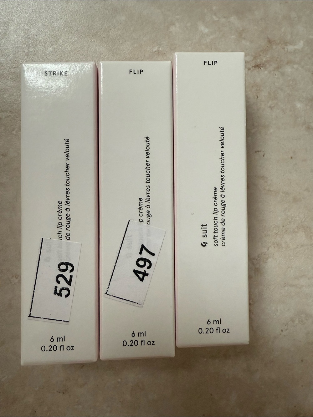 Glossier lip crème set in white and pink packaging